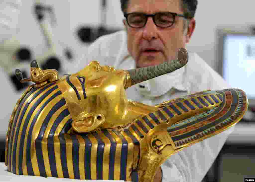 German conservator Christian Eckmann works on the restoration of the golden mask of King Tutankhamun at the Egyptian Museum in Cairo, Oct. 20, 2015.