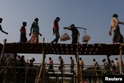 Rohingya refugees cross two bridges at Kutupalong refugee camp, near Cox's Bazar, Bangladesh, Nov. 28, 2017.