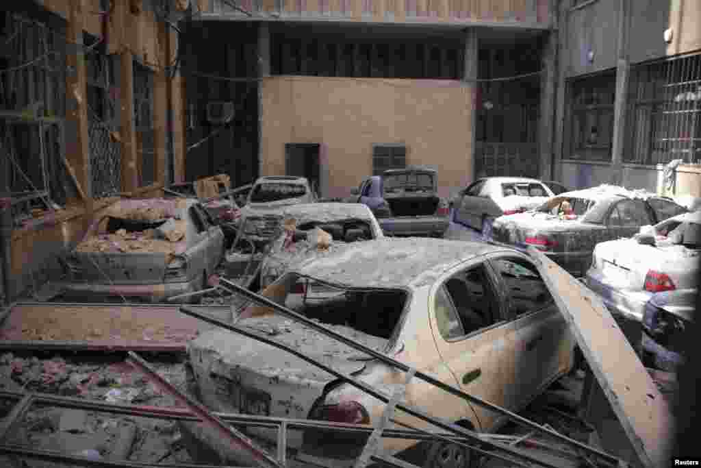 Damaged cars are seen within the compound of the justice palace in the old city of Aleppo, Feb. 10, 2014.