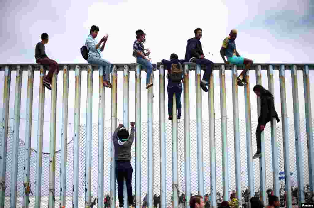 Members of a caravan of migrants from Central America climb up the border fence between Mexico and the U.S., in Tijuana, Mexico, as a part of a demonstration prior to preparations for an asylum request in the U.S., April 29, 2018.