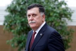 FILE - Libyan Prime Minister Fayez al-Sarraj leaves after an international conference on Libya at the Elysee Palace in Paris, May 29, 2018.