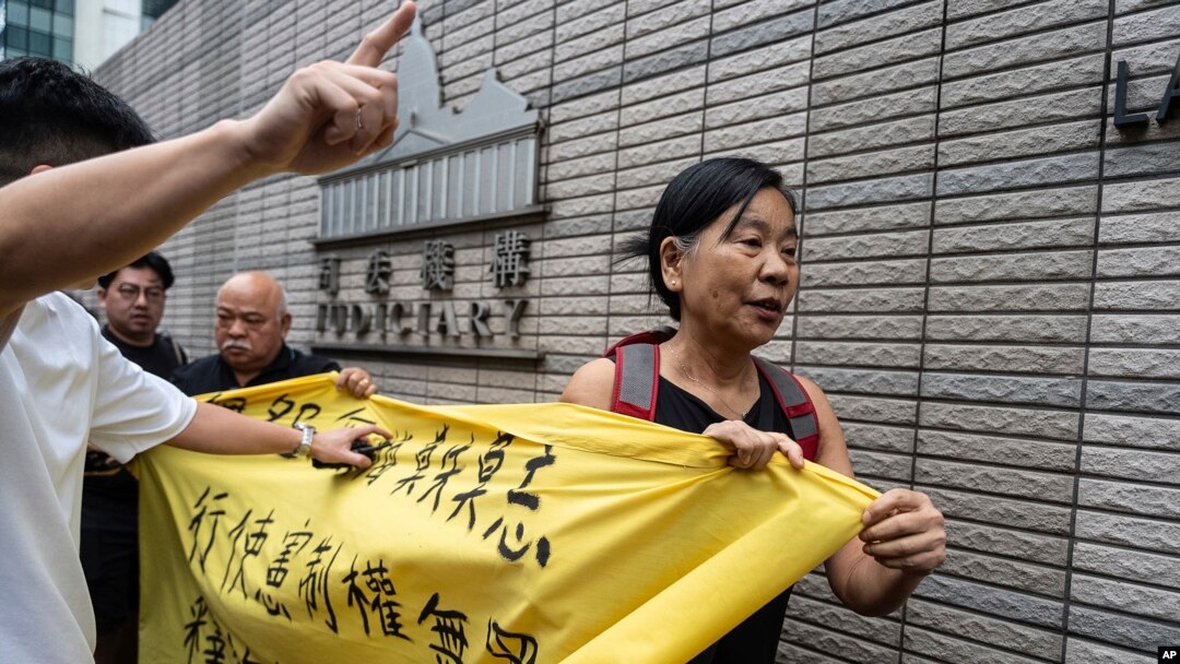 FILE - Members of League of Social Democrats hold banner outside the West Kowloon Magistrates' Courts in Hong Kong, May 30, 2024, ahead of verdicts in national security case. The banner reads "Exercising Constitutional rights is not a crime."