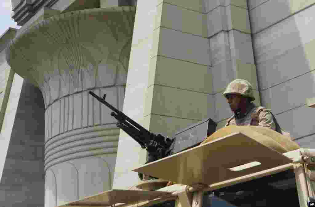 An Egyptian Army soldier takes his position on top of an armored vehicle as he guards in front of the Supreme Constitutional court in Cairo, August 19, 2013.