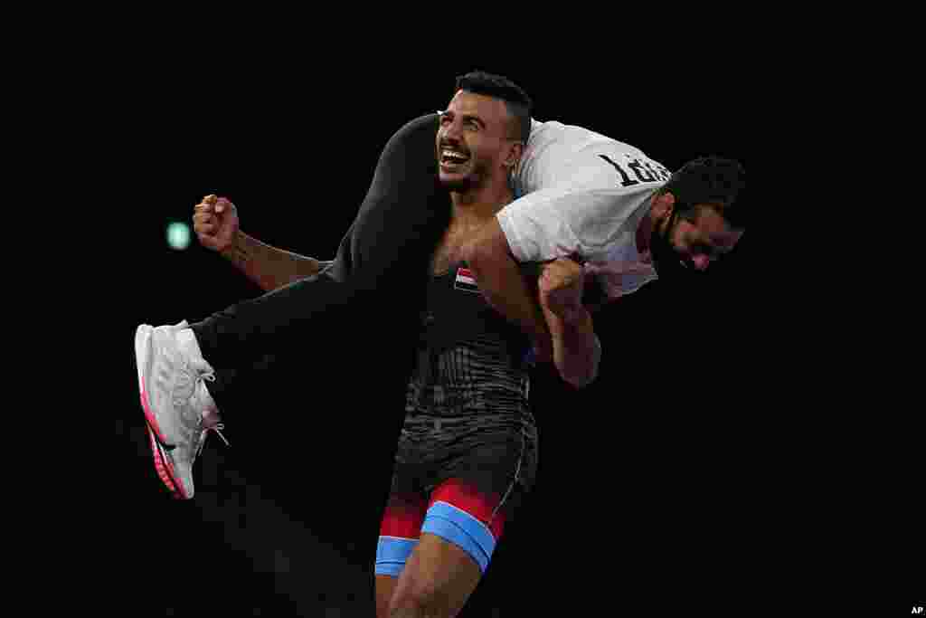 Mohamed Ibrahim Elsayed of Egypt celebrates defeating Russian Olympic Committee's Artem Surkov during the men's 67kg Greco-Roman wrestling bronze medal match at the 2020 Summer Olympics, Wednesday, Aug. 4, 2021, in Chiba, Japan. (AP Photo/Aaron Favila)