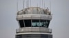 A man gestures inside the control tower of Reagan National Airport after an American Airlines flight crashed into the river after colliding with a U.S. Army helicopter, near Washington, D.C., Jan. 30, 2025.