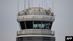 A man gestures inside the control tower of Reagan National Airport after an American Airlines flight crashed into the river after colliding with a U.S. Army helicopter, near Washington, D.C., Jan. 30, 2025.