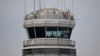 A man gestures inside the control tower of Reagan National Airport after an American Airlines flight crashed into the river after colliding with a US Army helicopter, near Washington, DC, on January 30, 2025.