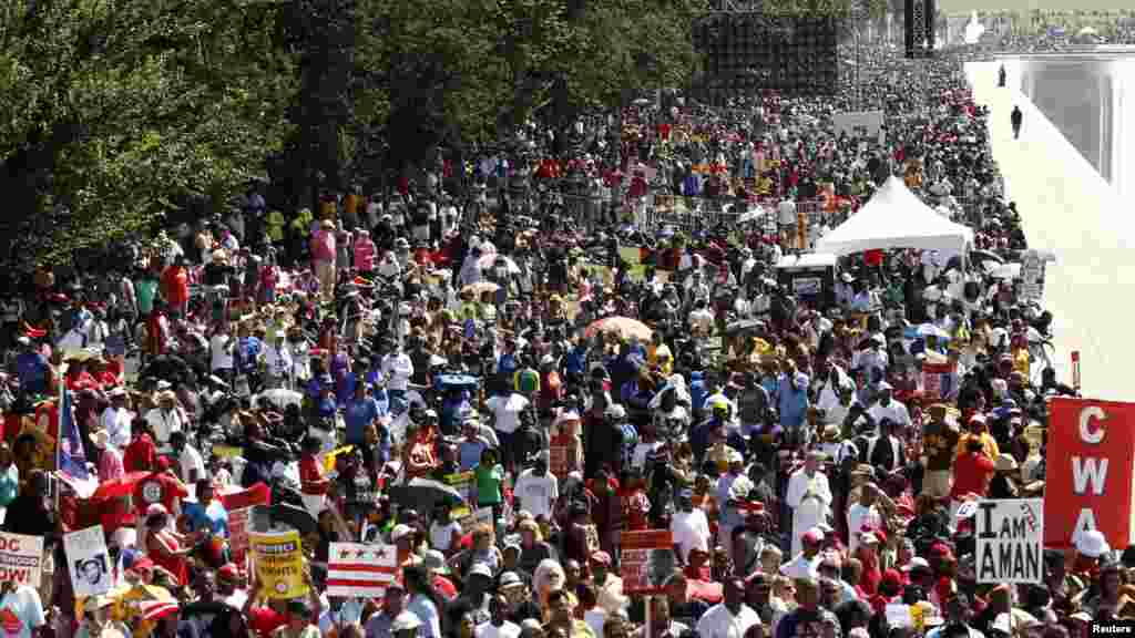 Rev. Bobby Turner or Columbus, Ohio, places his hand on the Martin Luther King Jr. Memorial, Aug. 22, 2013, in Washington.