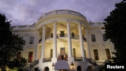 U.S. President Donald Trump poses atop the Truman Balcony of the White House after taking off his mask as he returns to the White House after being hospitalized at Walter Reed Medical Center for coronavirus disease (COVID-19), in Washington, U.S. October 