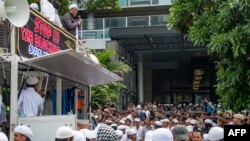 Members of a hardline Muslim group gather for a demonstration outside the Facebook office building in Jakarta, Jan. 12, 2018.