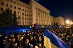Activists attend a "Night Watch" rally in front of the Office of Ukraine's President, in Kyiv, Dec. 8, 2019, demanding "no capitulation" ahead of Volodymyr Zelenskiy's talks with Russia's Vladimir Putin in Paris Monday.