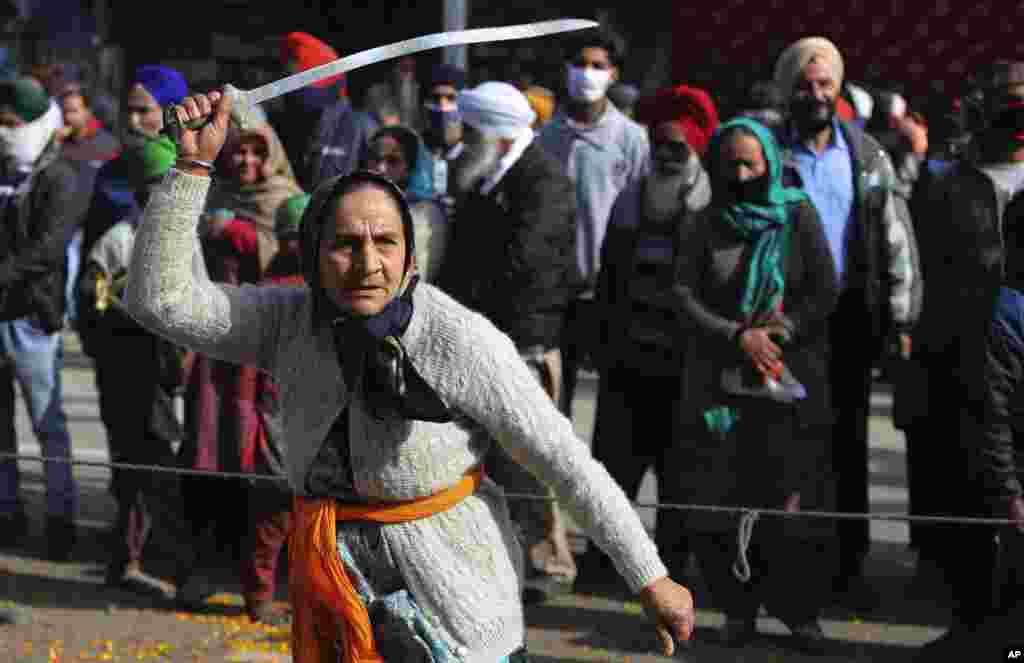 A&nbsp; Sikh woman displays traditional martial art skills during a religious procession ahead of the birth anniversary of Guru Gobind Singh in Jammu, India.