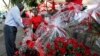 A Kenyan woman sells a bouquet of red roses to a customer for celebrations of Valentine's Day at a flower market in Nairobi, Kenya, February 14, 2012.