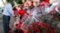 A Kenyan woman sells a bouquet of red roses to a customer for celebrations of Valentine's Day at a flower market in Nairobi, Kenya, February 14, 2012.