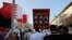 Bahraini anti-government protesters wave national flags and raise images of jailed Shiite opposition leader Sheikh Ali Salman and other protesters sentenced to death as they chant slogans demanding their freedom during a protest in Daih, Bahrain, Monday, 
