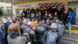 People queue to cast their votes at the entrance of a polling station during parliamentary elections, in Moscow, Russia, Sept. 17, 2021.