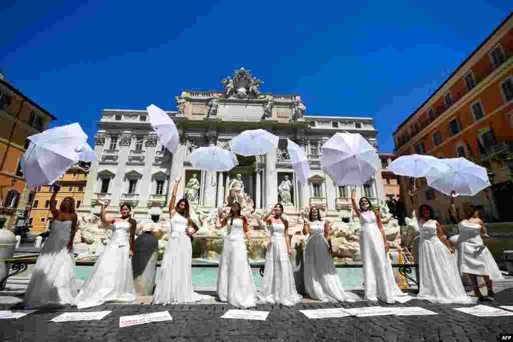 Women wearing wedding dresses stage a flashmob protest by the Trevi fountain in Rome, Italy, on July 7, 2020.