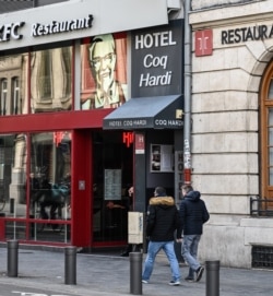 People walk in front of the Coq Hardi hotel near the train station in central Lille, northern France, Feb. 11, 2020, where Chechen blogger Imran Aliev was found dead on Jan. 30, 2020, by French emergency services.