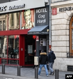 People walk in front of the Coq Hardi hotel near the train station in central Lille, northern France, Feb. 11, 2020, where Chechen blogger Imran Aliev was found dead on Jan. 30, 2020, by French emergency services.