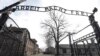 FILE - The entrance gate is seen at the Auschwitz-Birkenau Nazi concentration camp in Oswiecim, Poland, Feb. 15, 2019. The sign above the gate reads in German "Work liberates."