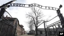 FILE - The entrance gate is seen at the Auschwitz-Birkenau Nazi concentration camp in Oswiecim, Poland, Feb. 15, 2019. The sign above the gate reads in German "Work liberates."