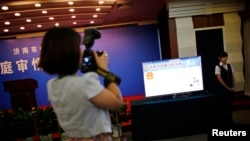 A Chinese journalist covering the trial of politician Bo Xilai in Shandong province in August.