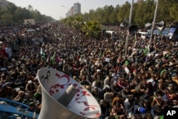 Supporters of cleric Tahir-ul Qadri listen to his speech at an anti-government rally in Islamabad, Pakistan, January 15, 2013.