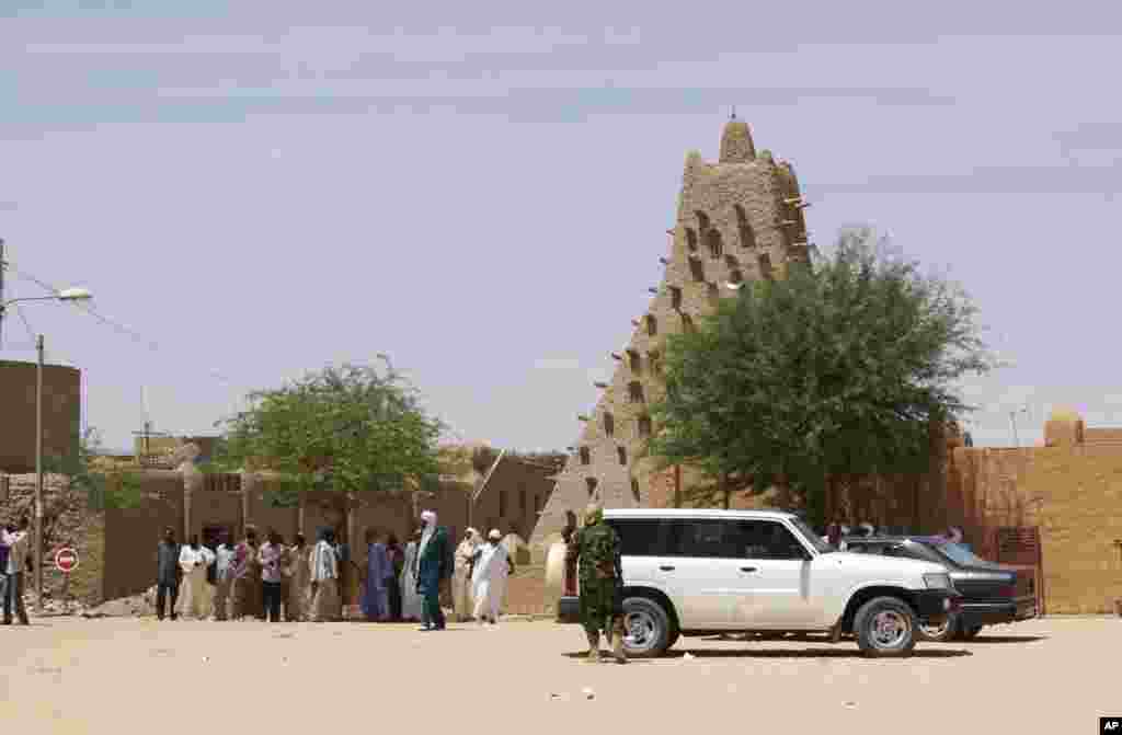 This April 15, 2012 shows town notables and two leaders of the Tuareg separatist NMLA in front of Sankore Mosque, a UNESCO World Heritage site, in Timbuktu, Mali.