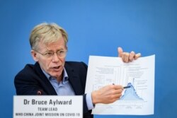 Team leader of the joint mission between World Health Organization and China on COVID-19, Bruce Aylward shows a graphic during a press conference at the WHO headquarters in Geneva on Feb. 25, 2020.