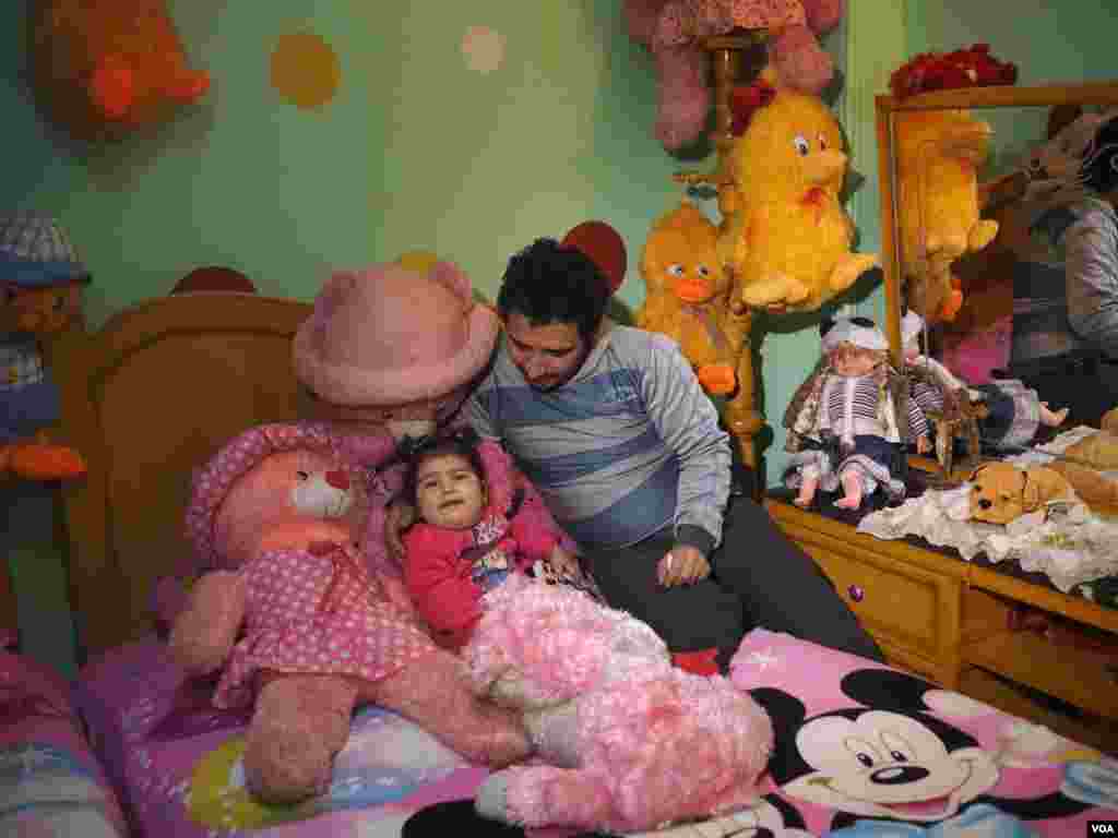Coptic Mousa Nazmy plays with his daughter, Anastasia, in his house in Cairo, Egypt, Jan. 6, 2017. “Playing with my daughter is my only happiness in life,” he said. “What I like about Christmas [is] that it’s a holiday, and I can spend more time with her.