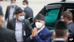 Nepal Prime Minister Khadga Prasad Oli, center, arrives at the parliament in Kathmandu, Nepal, May 10, 2021. 