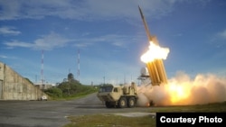 A Terminal High Altitude Area Defense (THAAD) missile interceptor is launched during a test in this photo provided by the U.S. Department of Defense.