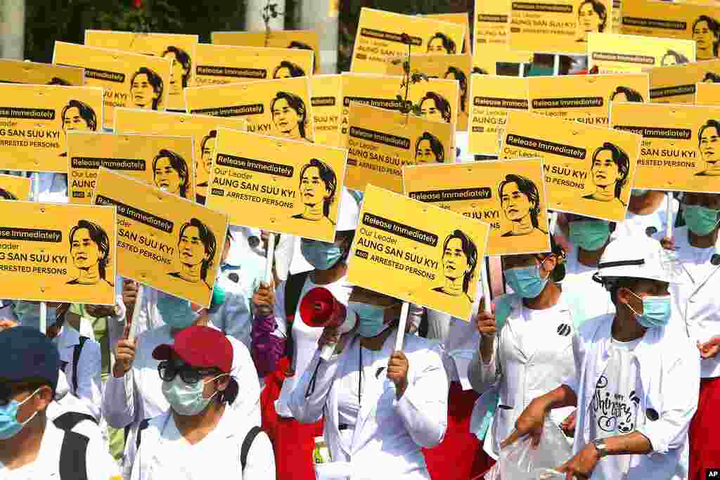 Medical students display images of deposed Myanmar leader Aung San Suu Kyi during a street march in Mandalay, Myanmar. By midday, security forces had blocked the main road in downtown Mandalay to prevent the protesters from gathering.
