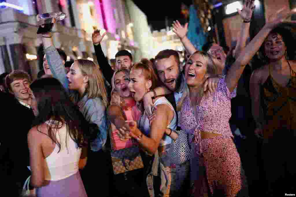 People sing and dance in Leicester Square amid the coronavirus disease (COVID-19) outbreak in London, Sept. 12, 2020.