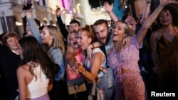 People sing and dance in Leicester Square amid the coronavirus disease (COVID-19) outbreak in London, Britain September 12, 2020. 