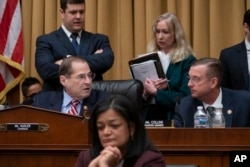 House Judiciary Committee Chair Jerrold Nadler, D-N.Y., joined at right by Ranking Member Doug Collins, R-Ga., passes a resolution to subpoena special counsel Robert Mueller's full report, on Capitol Hill in Washington, Wednesday, April 3, 2019.