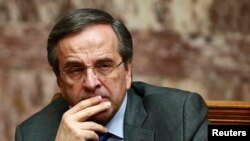 Greece's Prime Minister Antonis Samaras reacts during the second of three rounds of a presidential vote at the Greek parliament in Athens, December 23, 2014.