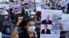 NagaWorld Casino workers hold up placards during a protest outside the National Assembly building after several union members were arrested, in Phnom Penh, Cambodia, on January 4, 2022. REUTERS/Cindy Liu