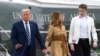 FILE - President Donald Trump, first lady Melania Trump and their son, Barron Trump, walk off of Marine One at Morristown Municipal Airport in Morristown, N.J., Aug. 16, 2020. 