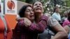 Supporters of Venezuela's President Hugo Chavez weep as she learn that Chavez has died through an announcement by the vice president in Caracas, Venezuela, Tuesday, Mar. 5, 2013. 