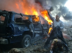 FILE - A Lebanese man shouts for help for a wounded man near the site of a car bomb explosion in Beirut February 14, 2005. A massive car bomb killed Lebanon's former prime minister Rafik al-Hariri on Beirut's waterfront . (REUTERS/ Mohamed Azakir/File Pho