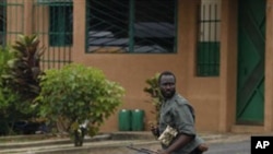 A Republican Forces soldier runs as security forces loyal to President Alassane Ouattara investigate reports of looting, in the Cocody neighborhood of Abidjan, Ivory Coast, April 13, 2011
