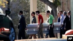 Pall bearers carry the casket of Scott Beigel after his funeral in Boca Raton, Florida, Feb. 18, 2018. 