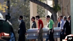 Pall bearers carry the casket of Scott Beigel after his funeral in Boca Raton, Fla., Sunday, Feb. 18, 2018. 