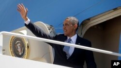 President Barack Obama waves as he boards Air Force One before his departure from Andrews Air Force Base, Md., May 2, 2013. 