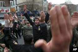 Iranian policemen mourn during a funeral ceremony for their three colleagues who were killed on Monday at a protest by followers of a Sufi Islam leader, in Tehran, Iran, Thursday, Feb. 22, 2018.