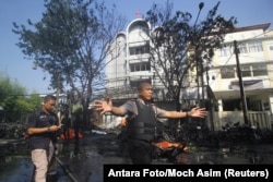 Police stand guard near the site of a blast at the Pentecost Church Central Surabaya, in Surabaya, East Java, Indonesia, May 13, 2018.