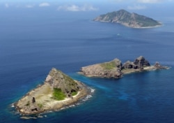 FILE - A group of disputed islands, Uotsuri island (top), Minamikojima (bottom) and Kitakojima, known as Senkaku in Japan and Diaoyu in China is seen in the East China Sea, in this photo taken by Kyodo September 2012.