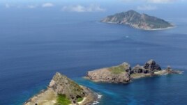 FILE - A group of disputed islands, Uotsuri island (top), Minamikojima (bottom) and Kitakojima, known as Senkaku in Japan and Diaoyu in China is seen in the East China Sea, in this photo taken by Kyodo September 2012.