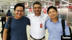 Myanmar photojournalists Minzayar Oo and Hkun Lat are seen with their lawyer in a photo posted on Twitter, Oct. 17, 2017.